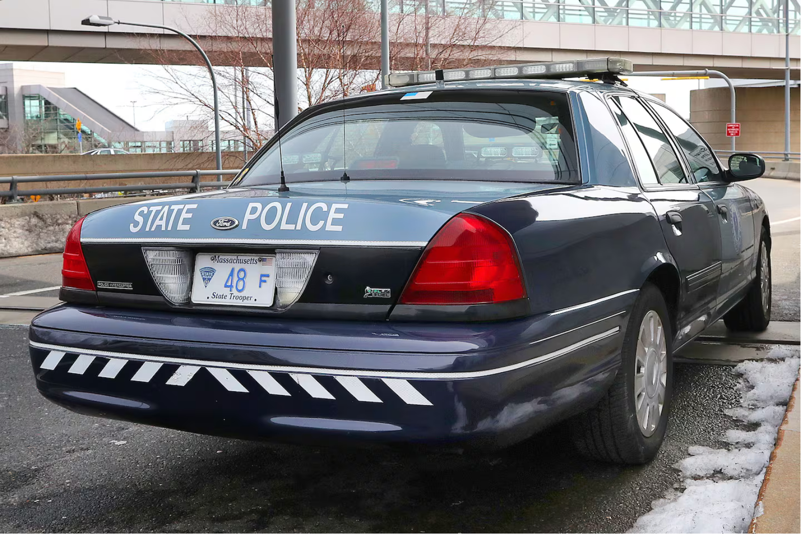 A Massachusetts State Police car parked in front of Terminal A at Logan Airport. A police sergeant was charged Thursday with vehicular homicide.John Tlumacki